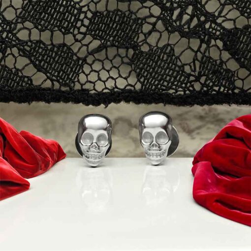 Skull ComfyEarrings in front of black lace and red velvet.