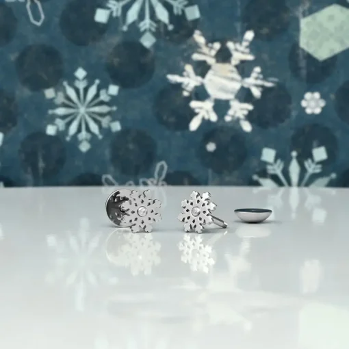 Snowflake with Gem ComfyEarrings in front of a snowflake backdrop.